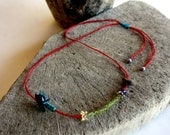 lovely driftwood and peridot necklace with traditional turkish needle lace on a red cotton cord...unique and one of a kind