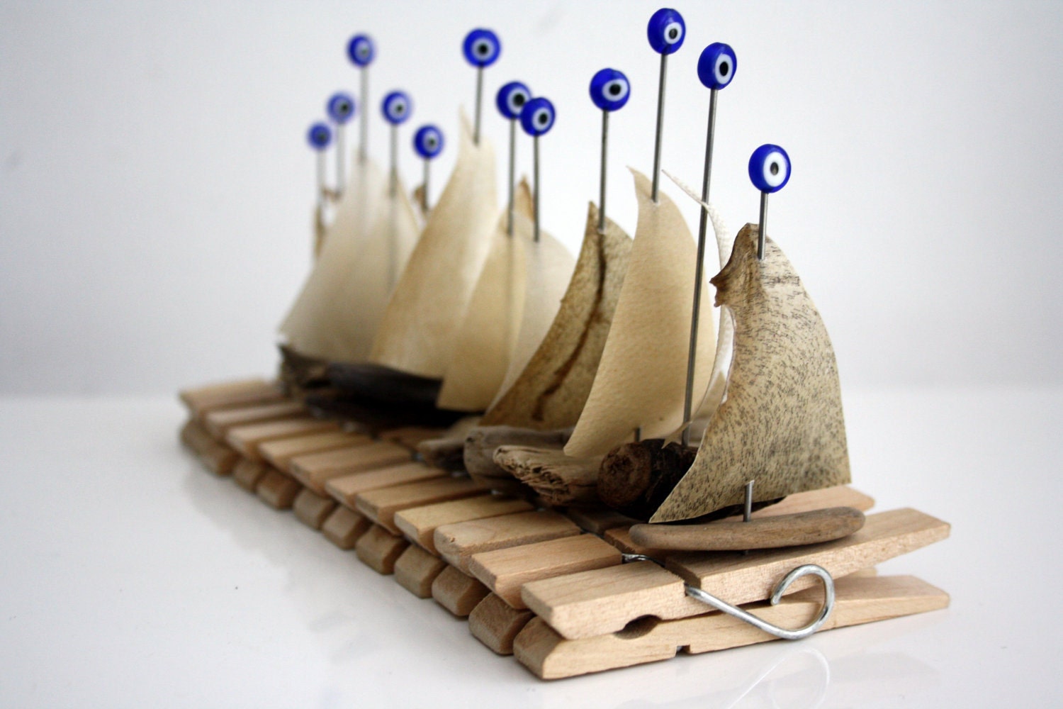 15 driftwood boats "peg-sail " with a sail from genuine parchment on a clothespin and "evil eye" glassbead...made to order