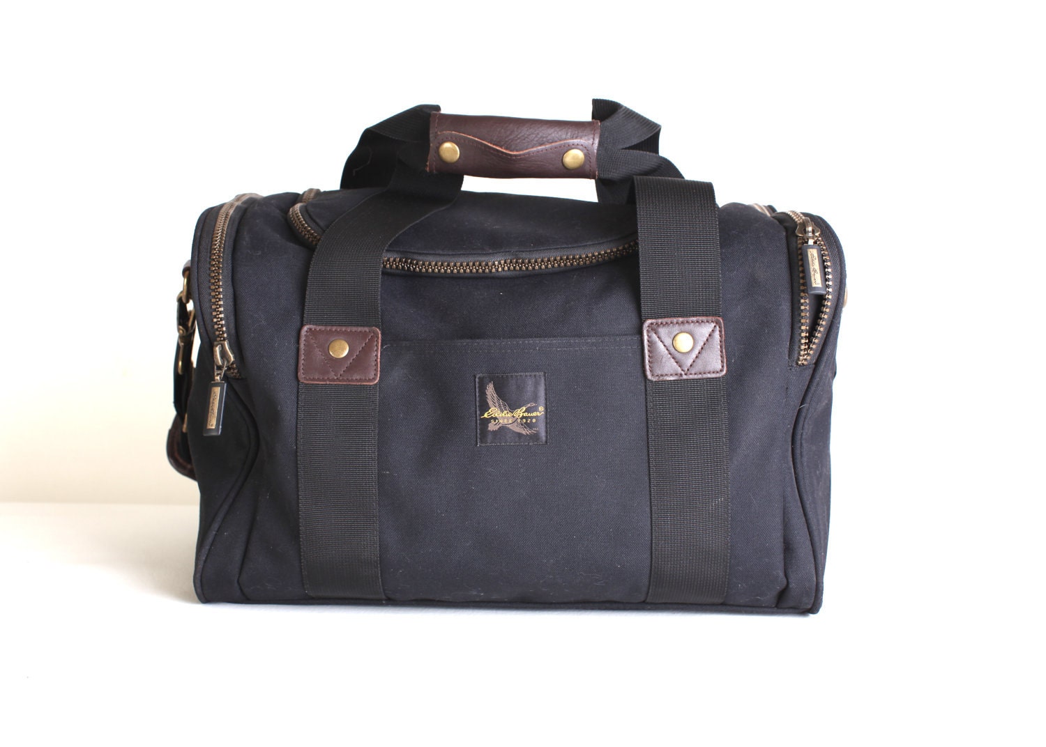 Black canvas duffel bag with brown leather accent, Large Eddie Bauer Duffel
