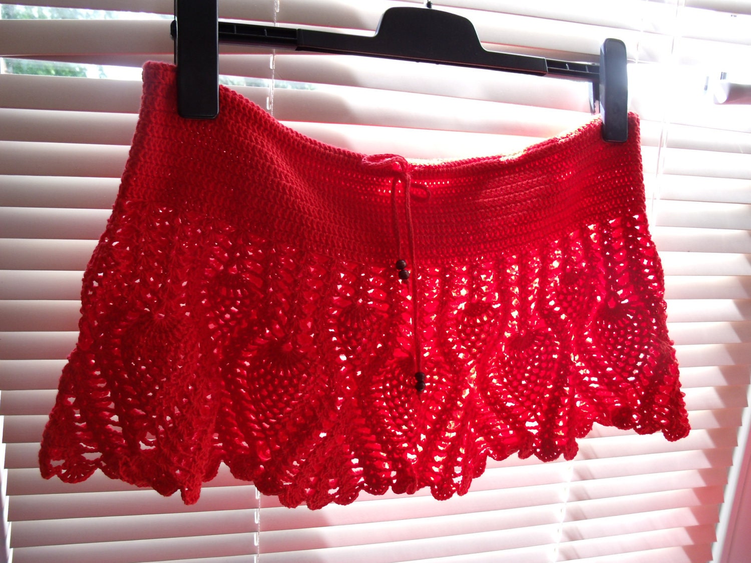Hand crochet summer beach mini skirt in red color docorated with wood beads