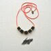 The Skyscraper Necklace- Jet Black Lava Rock and Hand Cut Raw Brass Squares