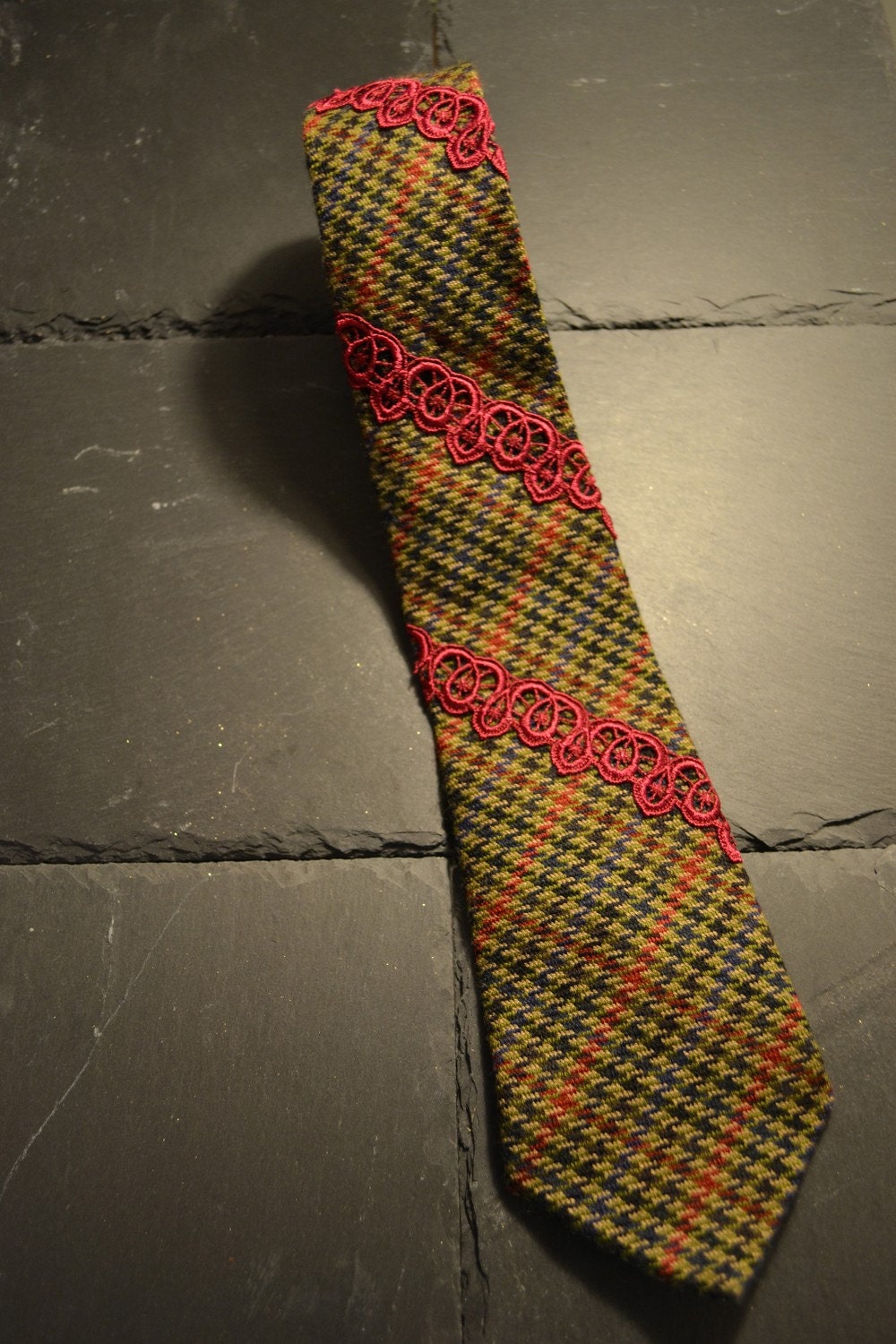Olive tweed necktie with jazzberry jam embroidery