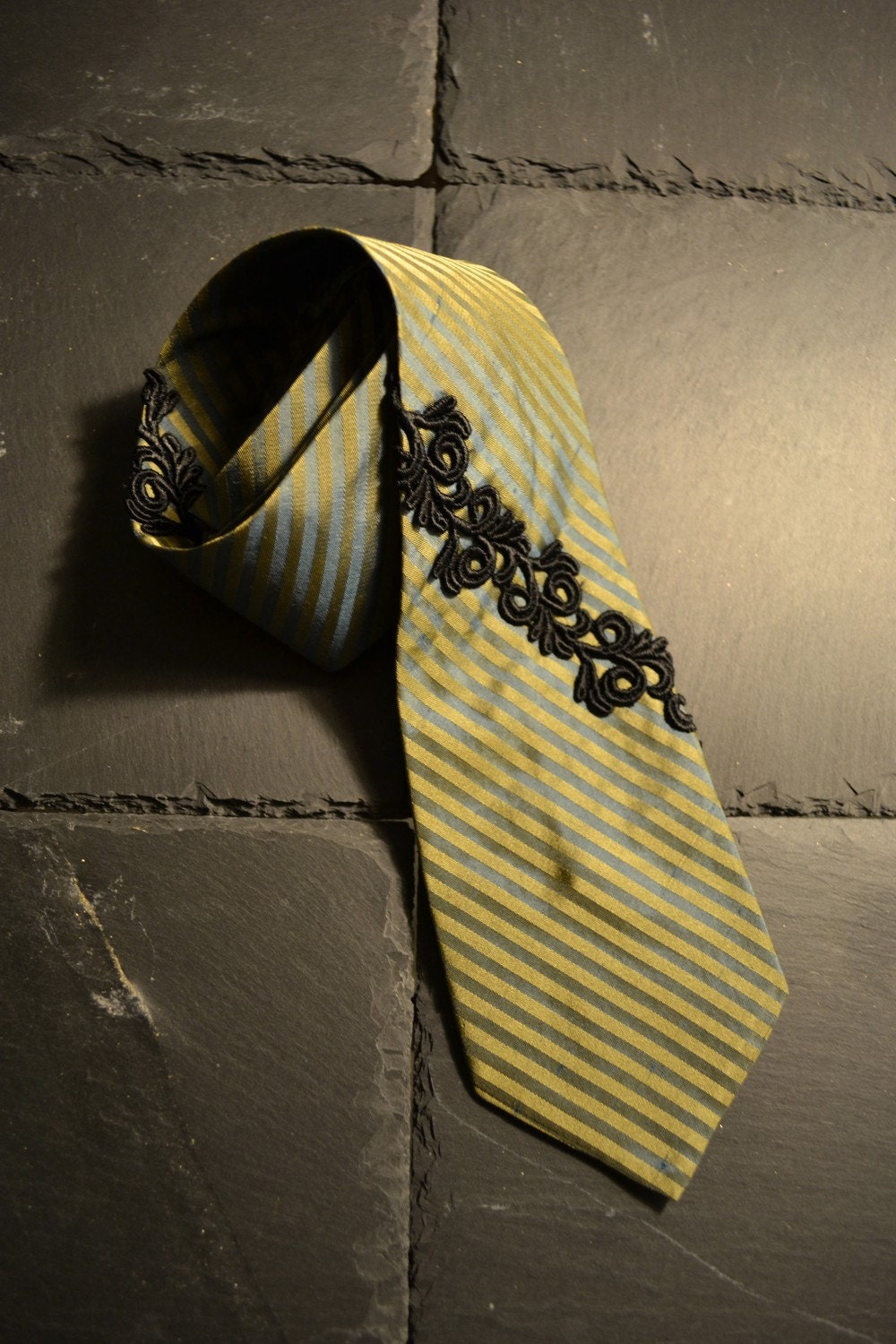 Turquoise / gold striped necktie with black embroidery adornment