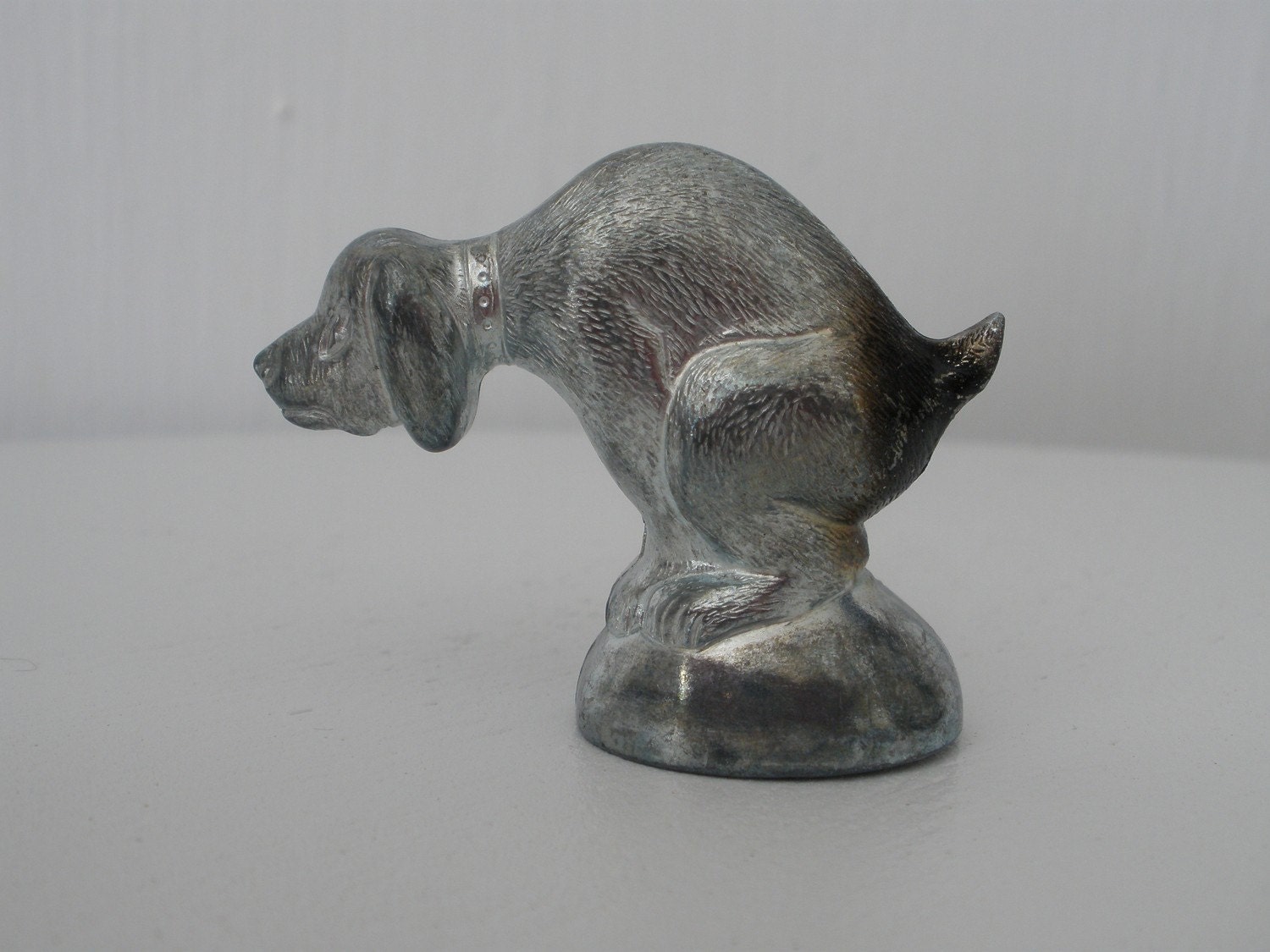 pooping dog figurine