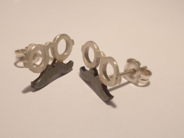Post silver earrings.The mustache and a pair of glasses.