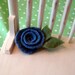 felted wool rosette on a small pinback