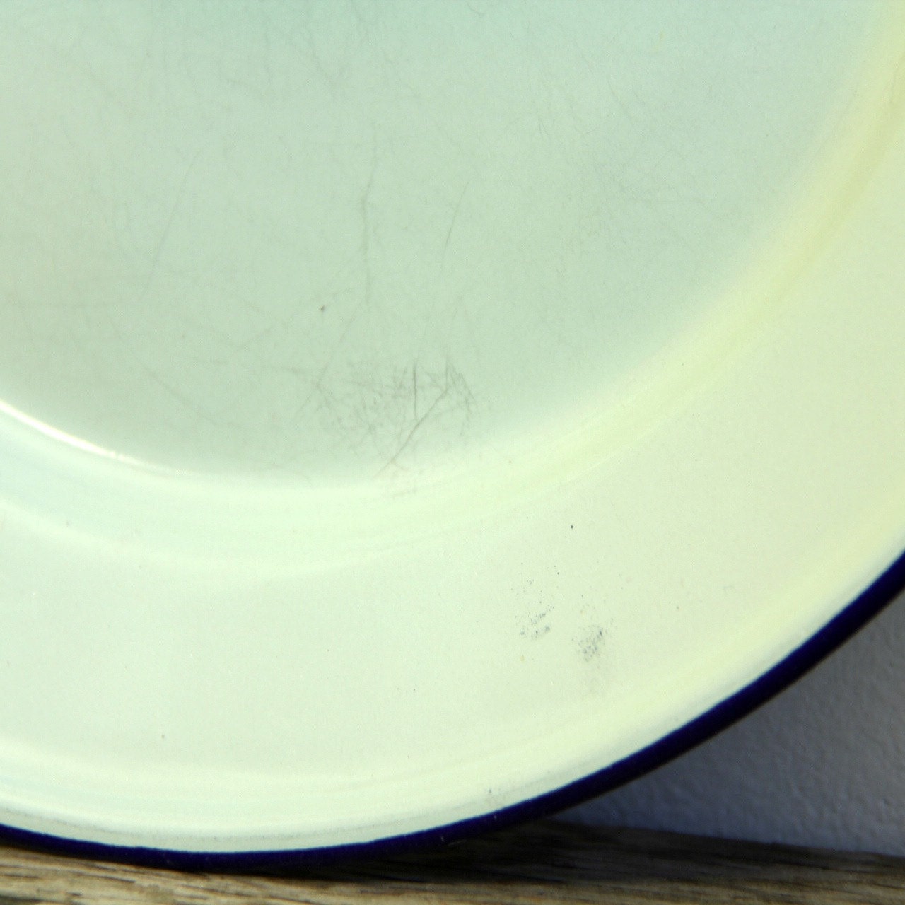 Mint green enamelware dinner plate with blue rim