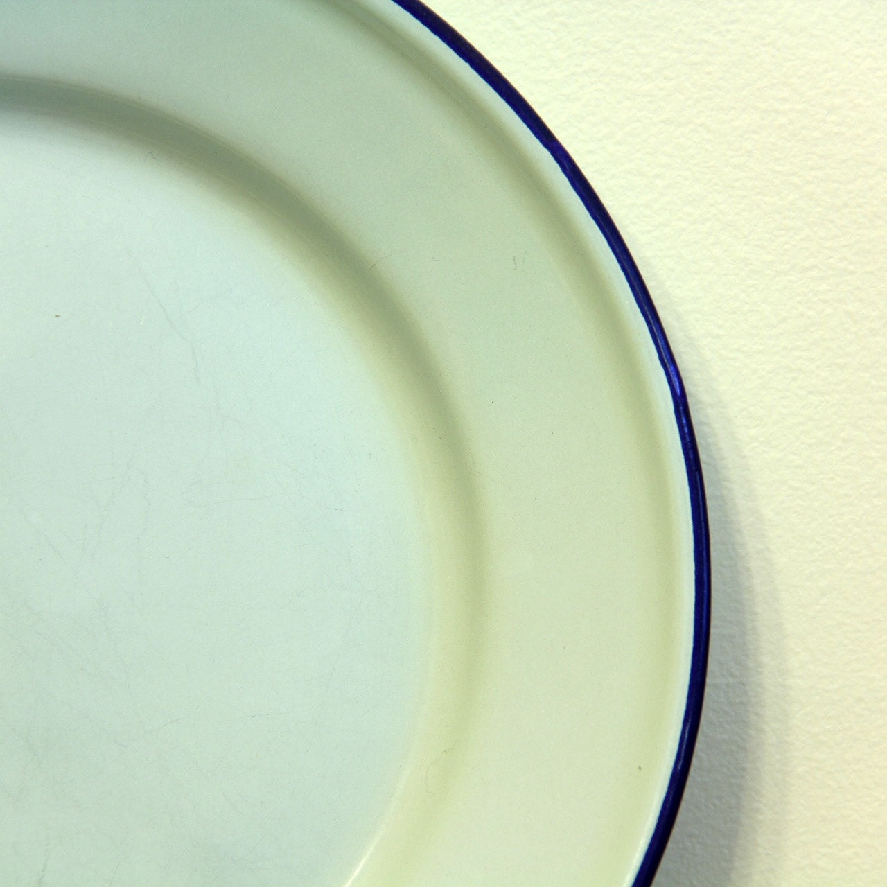 Mint green enamelware dinner plate with blue rim