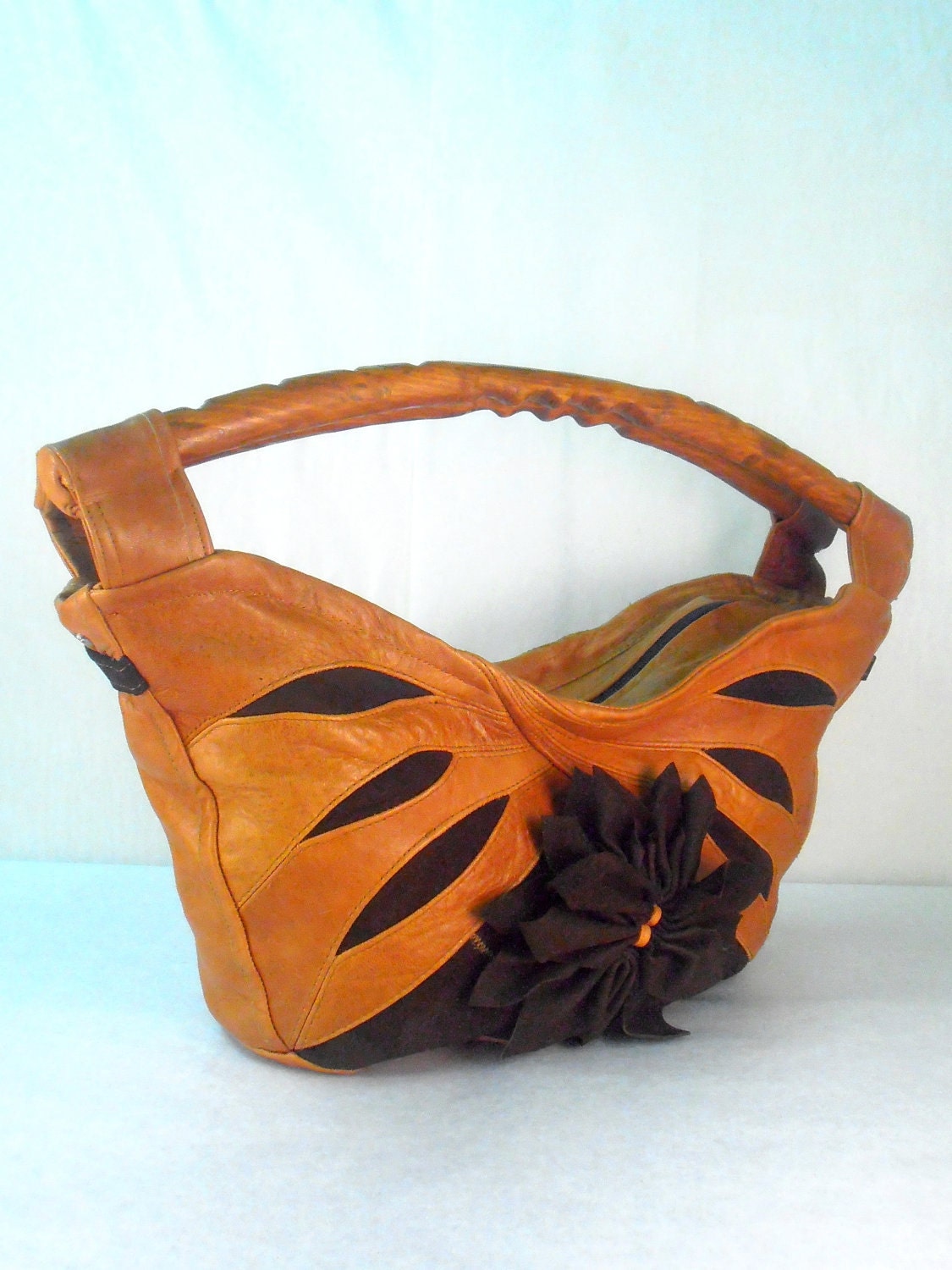modern ocher-brown leather bag with wooden handles