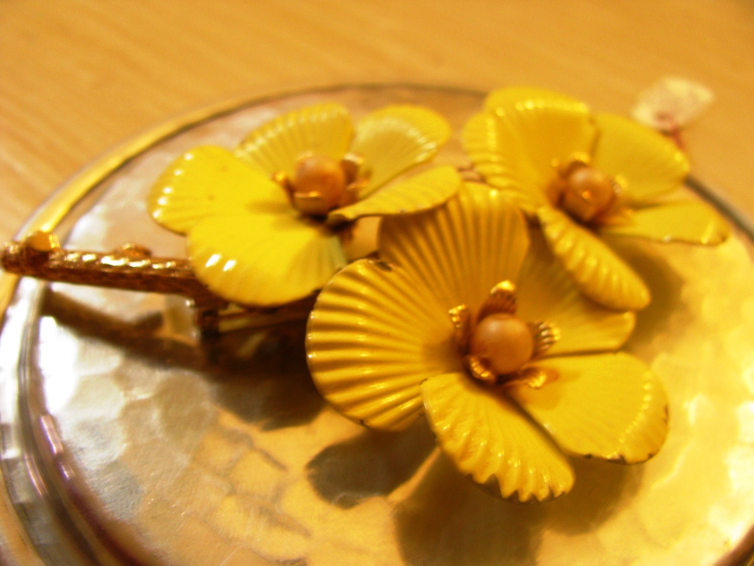 Emmons crimped yellow flowers brooch with faux pearl centers. Three inches across.