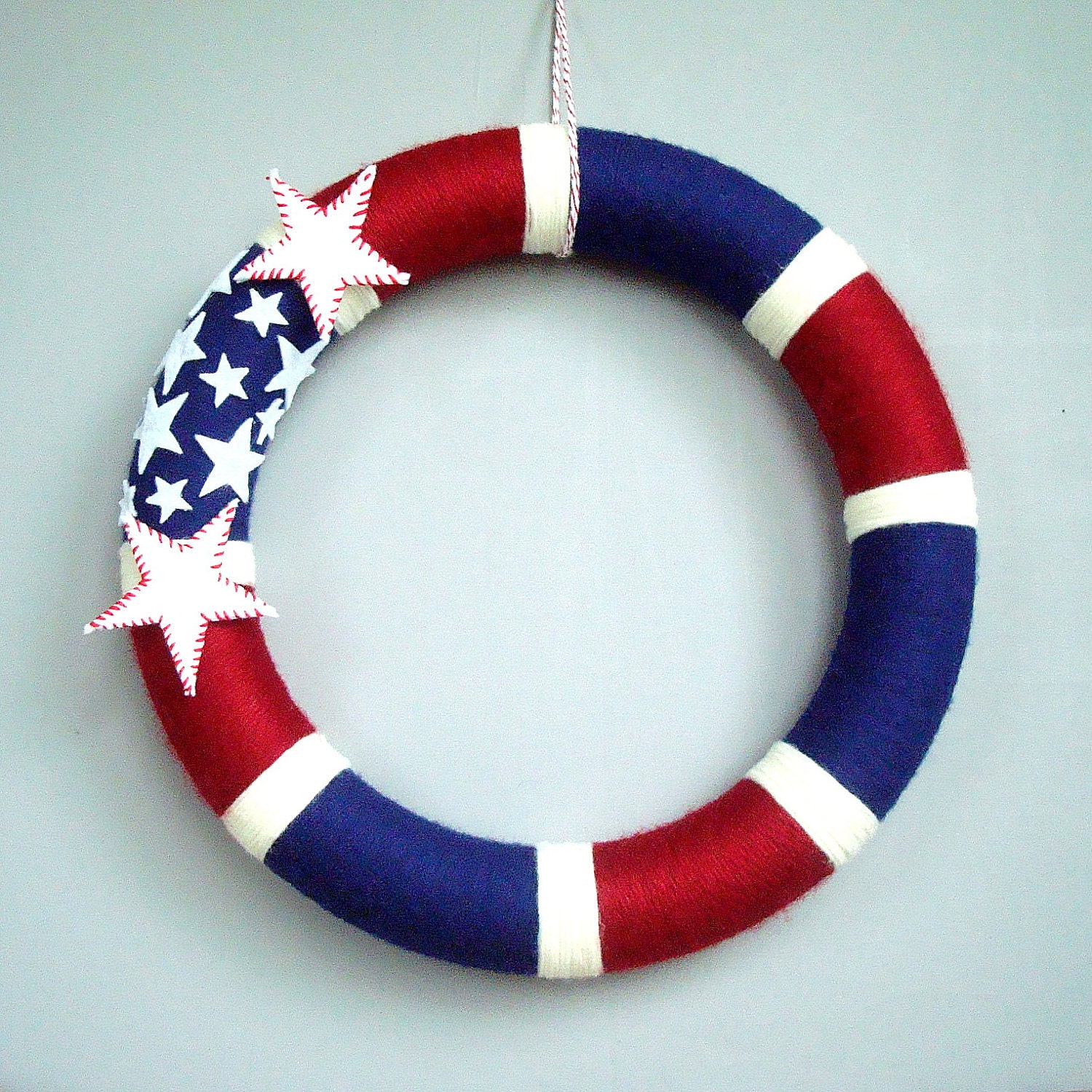 American Yarn Wreath. 14 inches. Patriotic wreath. Red, white and blue stripes with white felt stars. Perfect for military families.