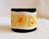 Bracelet white yellow black orange spring fiber art hand embroidery
