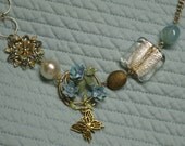 Repurposed blue floral brooch with butterfly embellishment