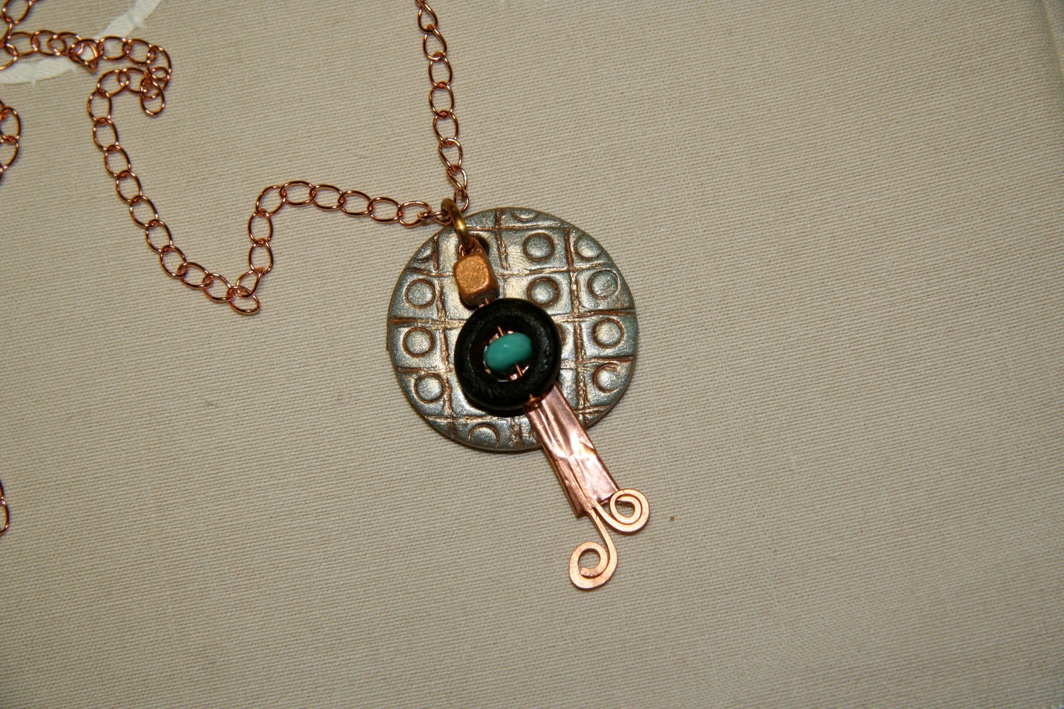Shimmering Handmade Polymer Clay Pendant with hammered copper design