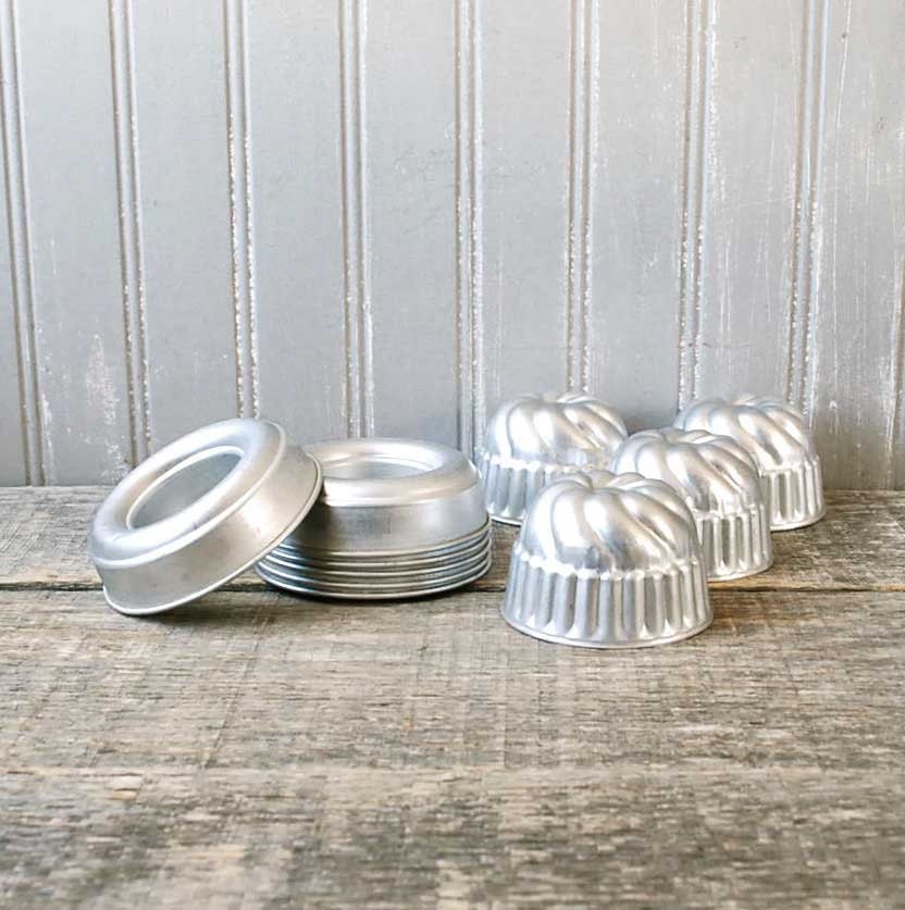 Two Sets of Midcentury stacking dessert molds. Set of 4 swirled aluminum Jell-o style molds and Set of 6 round aluminum aspic style molds