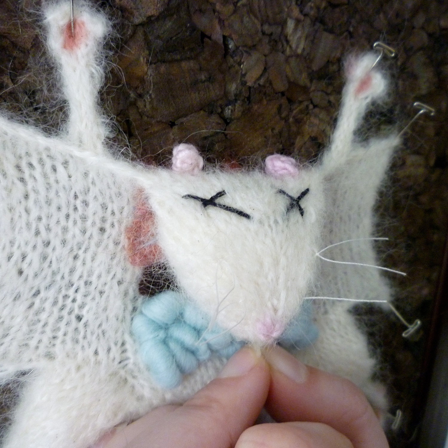 Knitted Lab Rat, dark cork background