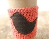 Cup cozy Orange with a bird on it by The Cozy Project