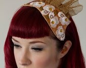 Gold and Lace tear drop hair piece on tan leather