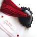 Red and black nipple tassels