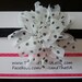White Chiffon Flower with Black Polka Dots on a Shimmery Black Stretch Headband.