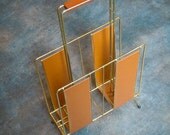 Stylish gold chromed metal 1950s magazine rack with teak handgrip