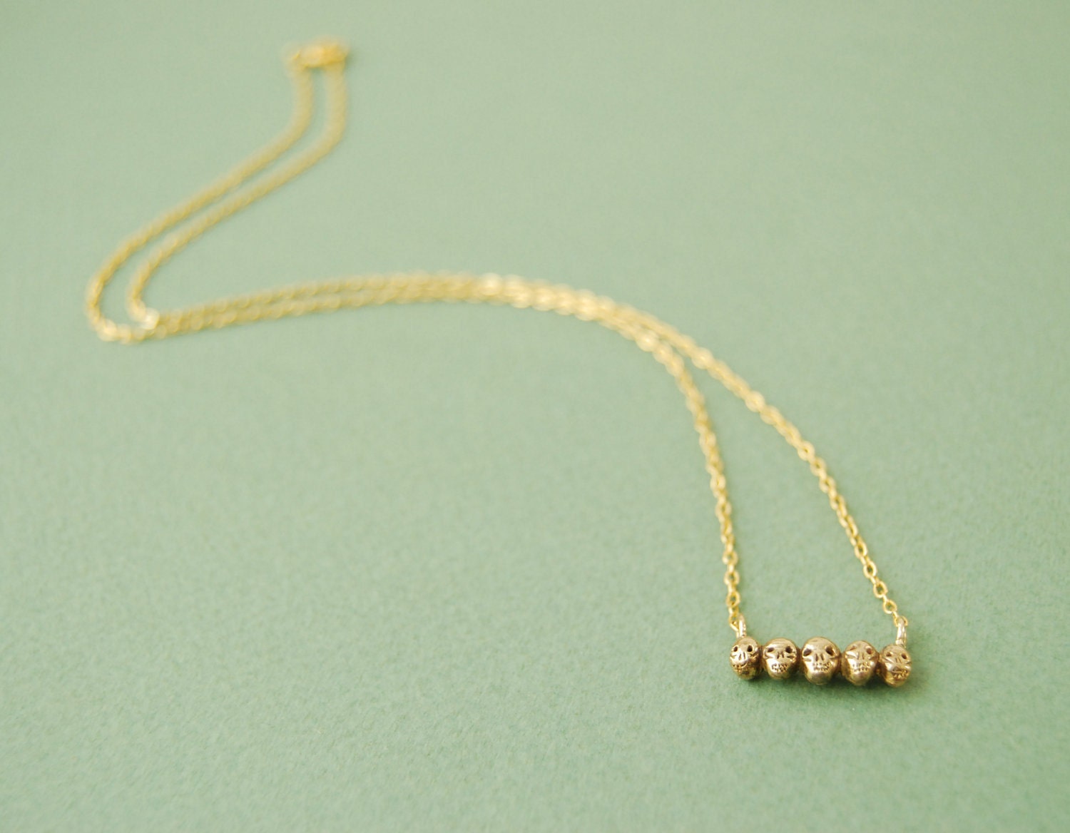 Tiny golden skull necklace