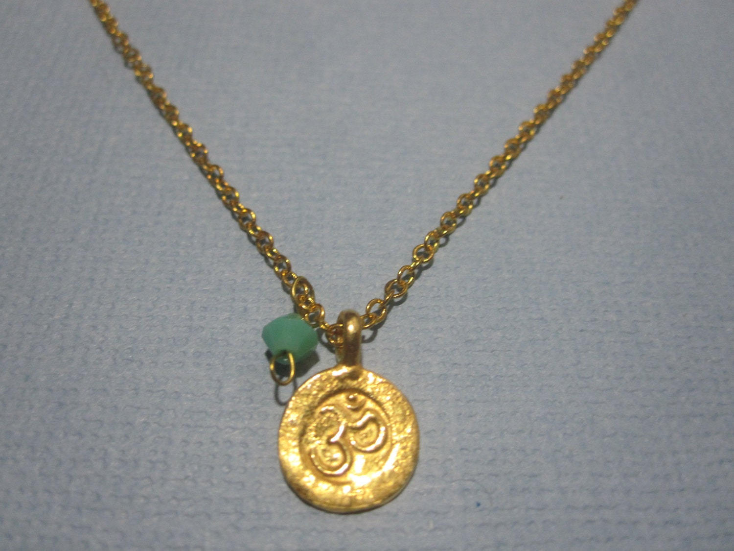 Tiny Sanskrit Om (ohm)  Necklace with swarovski crystal detail available in gold or silver