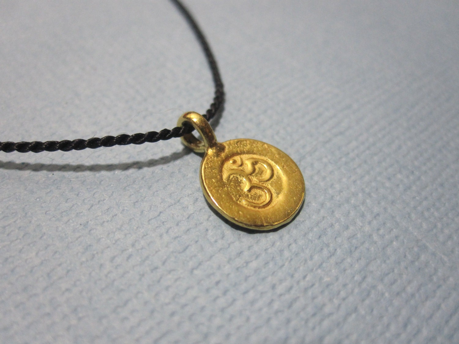 Silk String Sanskrit Om Wish Necklace available in gold or silver
