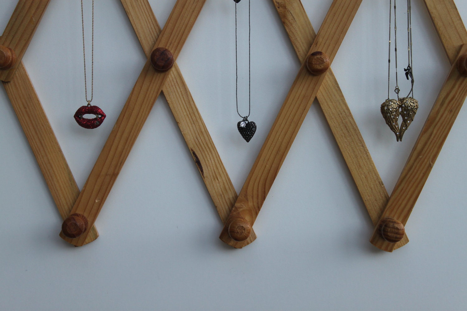 Vintage wooden accordion peg rack
