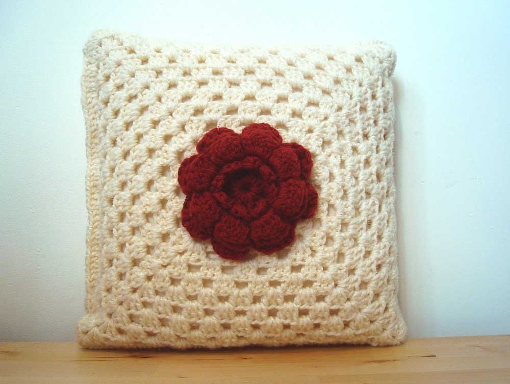 burnt red flower on white. crochet granny square cushion cover