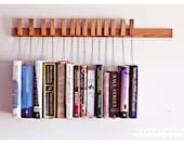 Custom made wooden book rack / bookshelf in Oak. The pins are also bookmarks. - OldAndCold