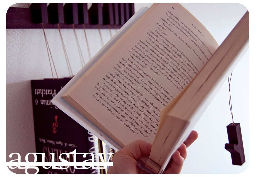 Custom made wooden book rack / bookshelf in Wenge. Pins also work as bookmarks. Bookcase