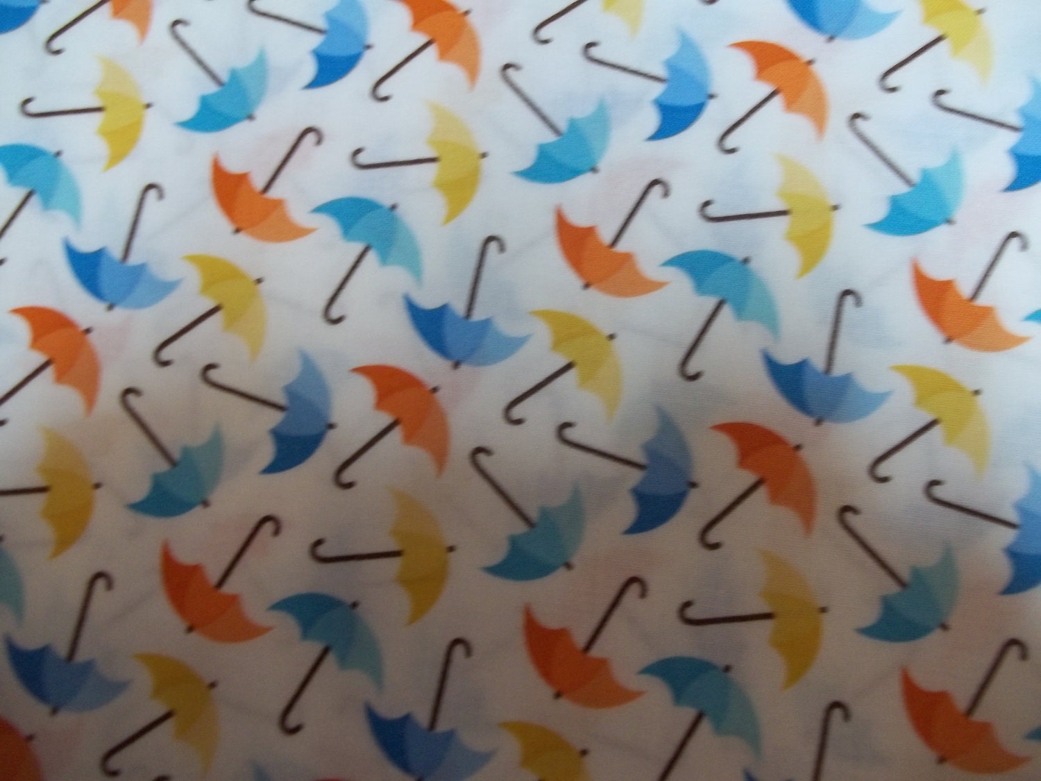 Fun and cheerful umbrella print with Rainbow colors in the back ground For Robert Kaufman Fabrics 1 yard Licensed Print