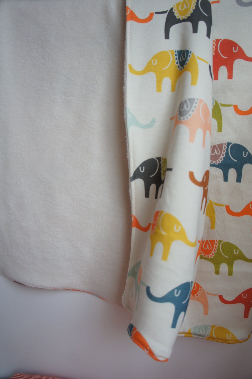 Rainbow Organic Baby Blanket: Circus Troupe on Elephant Parade printed on Cotton Jersey with cream Poly Fleece blanket.