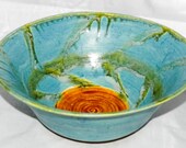 Blue ceramic bowl with golden ash glaze