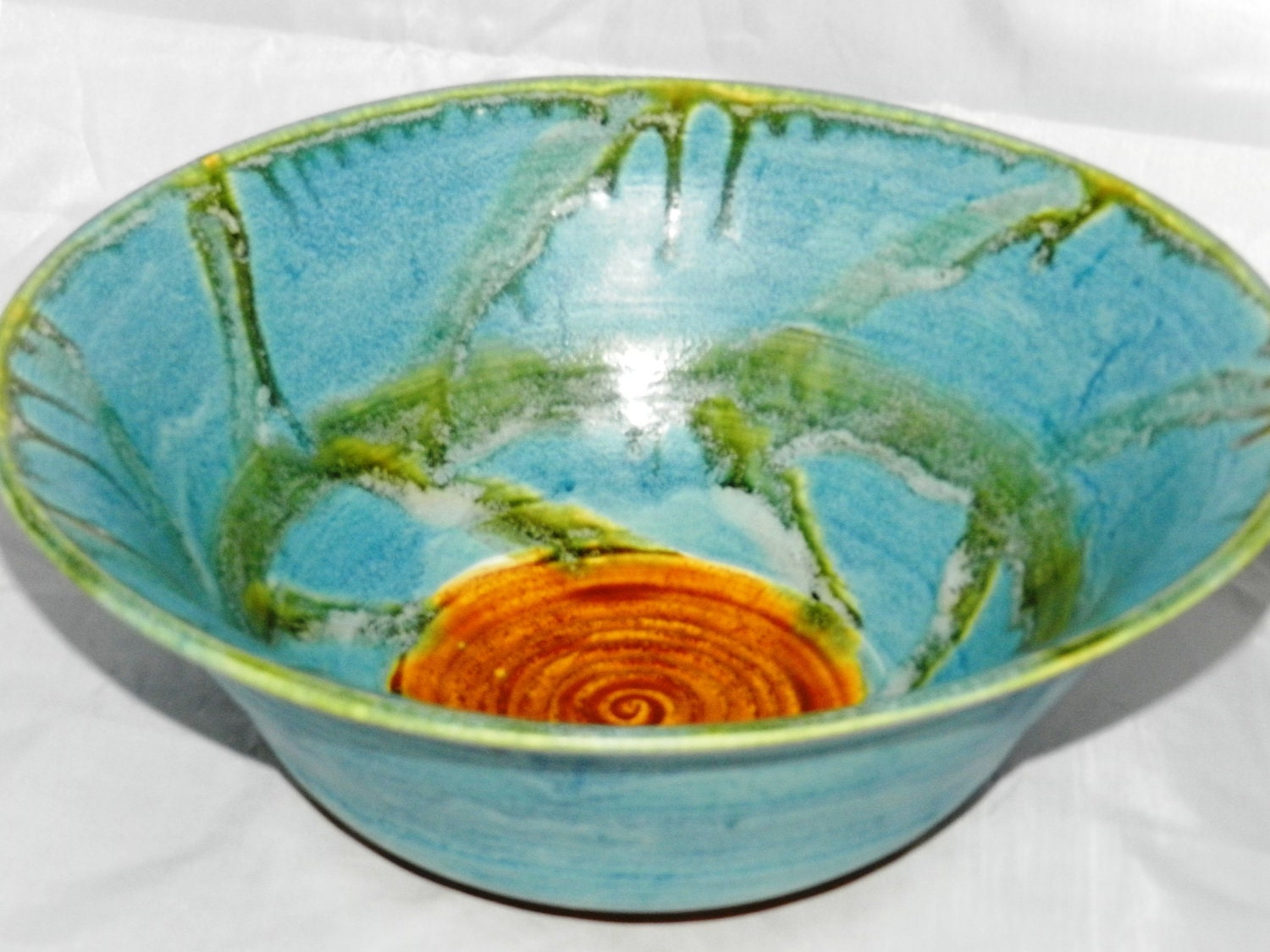 Blue ceramic bowl with golden ash glaze