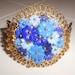 Vintage floral cuff hinged bracelet with celluloid blue flowers