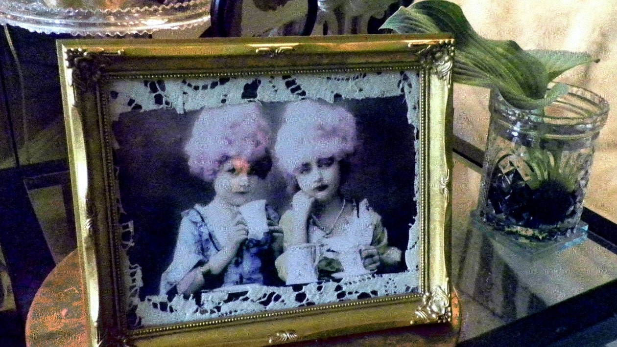 Assemblage art tea party image of pink wigged  girls in lace trim and frame.