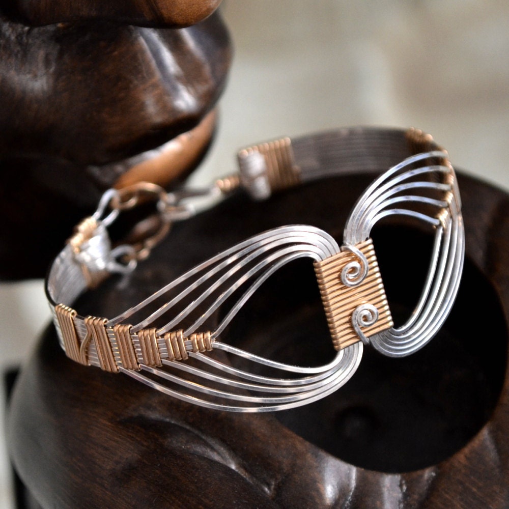 Egyptian wire wrapped Bracelet with a Twist.  Sterling Silver and 14K Gold filled. Size Small