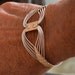 Egyptian wire wrapped Bracelet with a Twist.  Sterling Silver and 14K Gold filled. Size Small