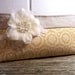 Clutch in a mustard fabric with linen and a white flower.