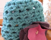 Bright teal newborn hat with purple flower