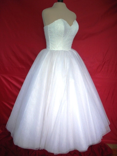 A 50s inspired wedding gown, intricately detailed corset cocktail dress
