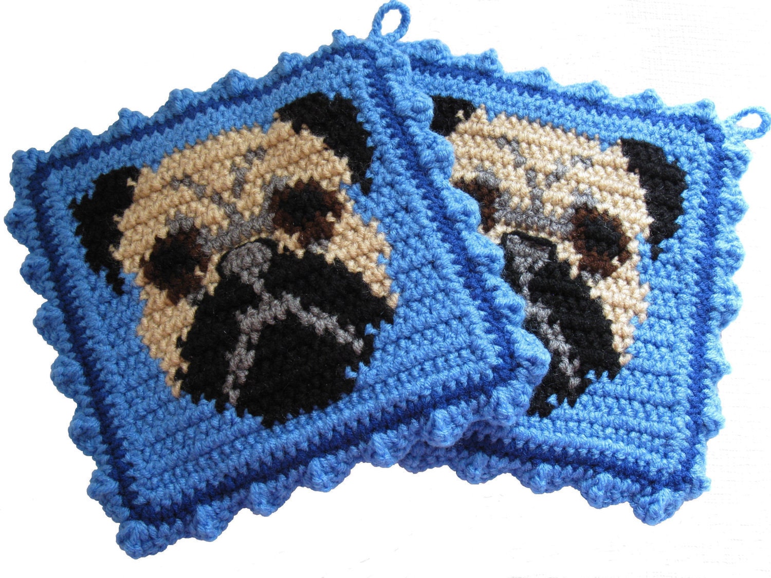 Pug Dog Pot Holders. Blue potholders with black and tan pugs.