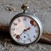 Antique pocket watch case with movement and dial.