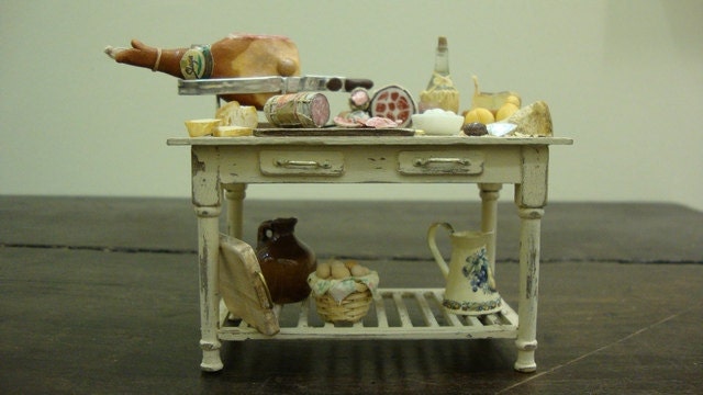 Miniature table shabby chic set up with salami and typical Italian products