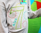 Personalized T-shirt for birthday child with age surrounded with robot gears.