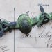 One Steampunk patina airplane stamping with working propellers and three loops