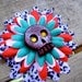 Burgendy glitter filled skull on purple leopard print flower base