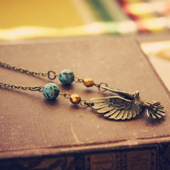 RESERVED FOR NAVIWING skylar.  a beaded brass bird in flight necklace.